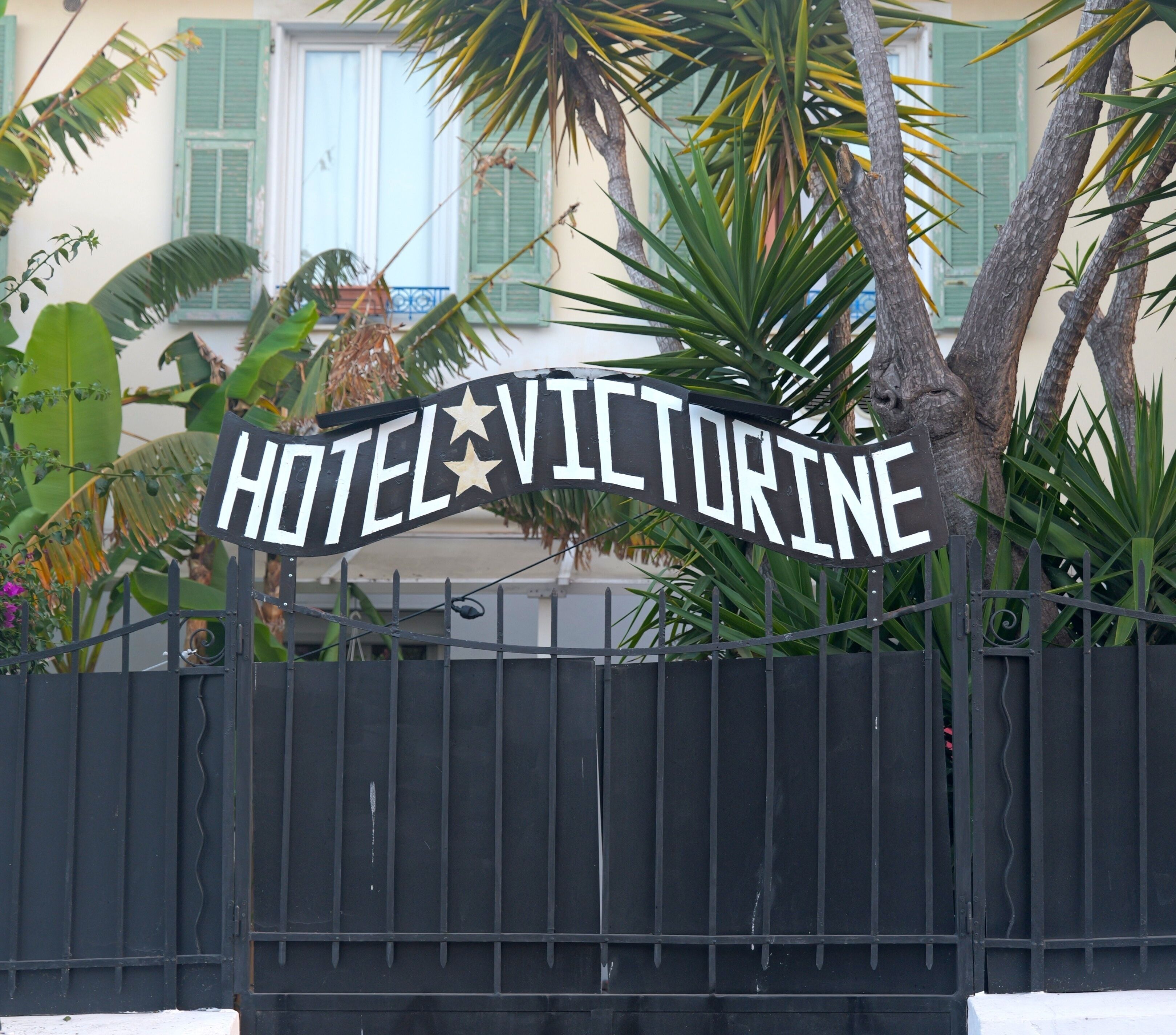 A hotel sign with the name 'HOTEL VICTORINE' and a decorative star.