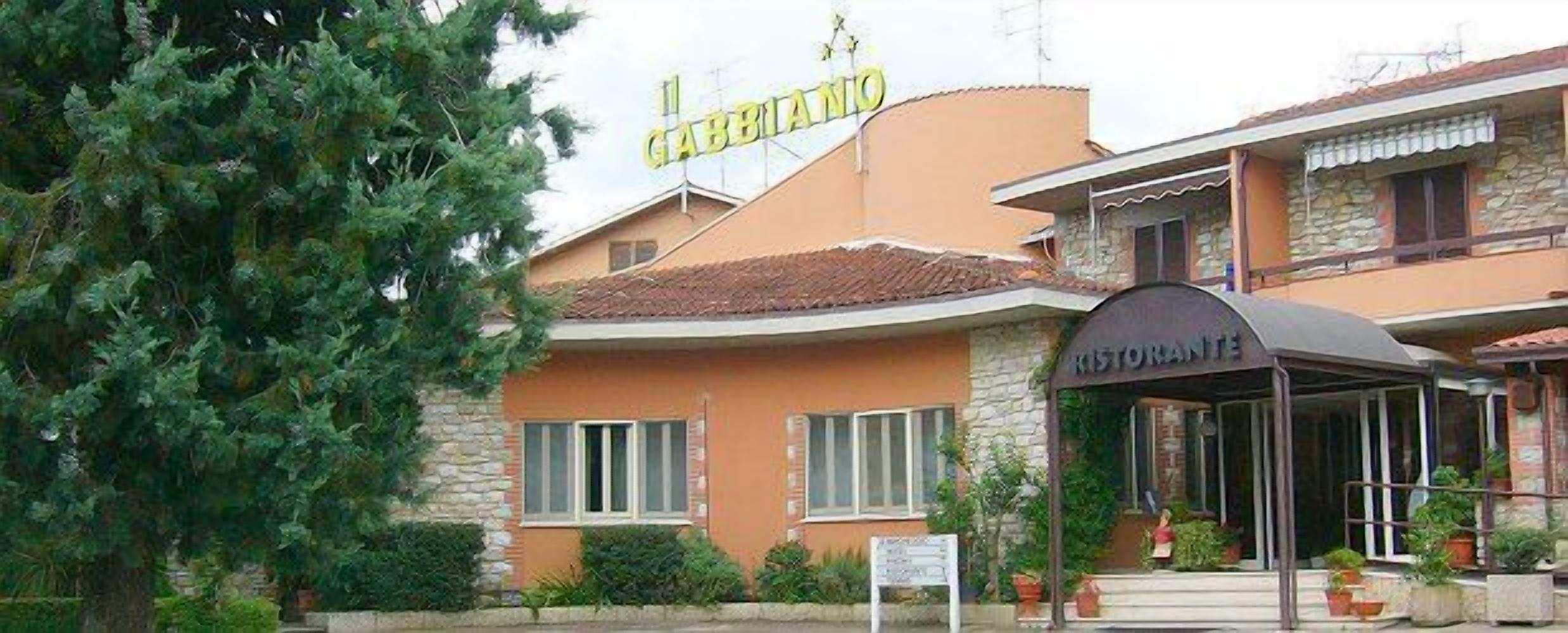 A building with a sign reading "GABBIANO" and a restaurant entrance.