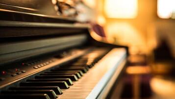 A close-up of a piano keyboard with a blurred background.