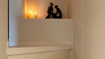 A staircase with white steps leading up to a landing.