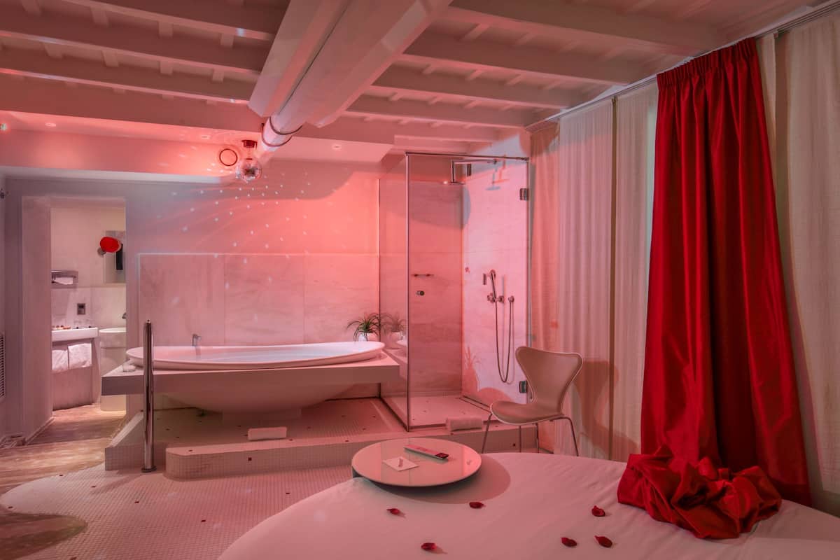 A modern bathroom with a bathtub, shower, and a vanity.