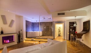 A modern bathroom with a glass-enclosed shower, a bathtub, and a vanity with a mirror.