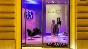 A hotel entrance with a reception desk, a purple interior, and a sign reading "suite Jitka."