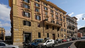 A multi-story building with a stone facade and multiple balconies. - Capricci Romani (Rome)