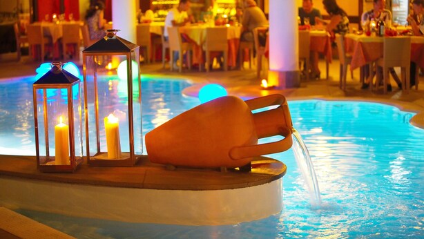 A poolside area with candles and a water feature. - Grand Hotel Arciduca (Lipari)