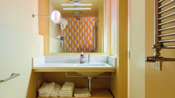 A bathroom with a bathtub, sink, and a towel rack.