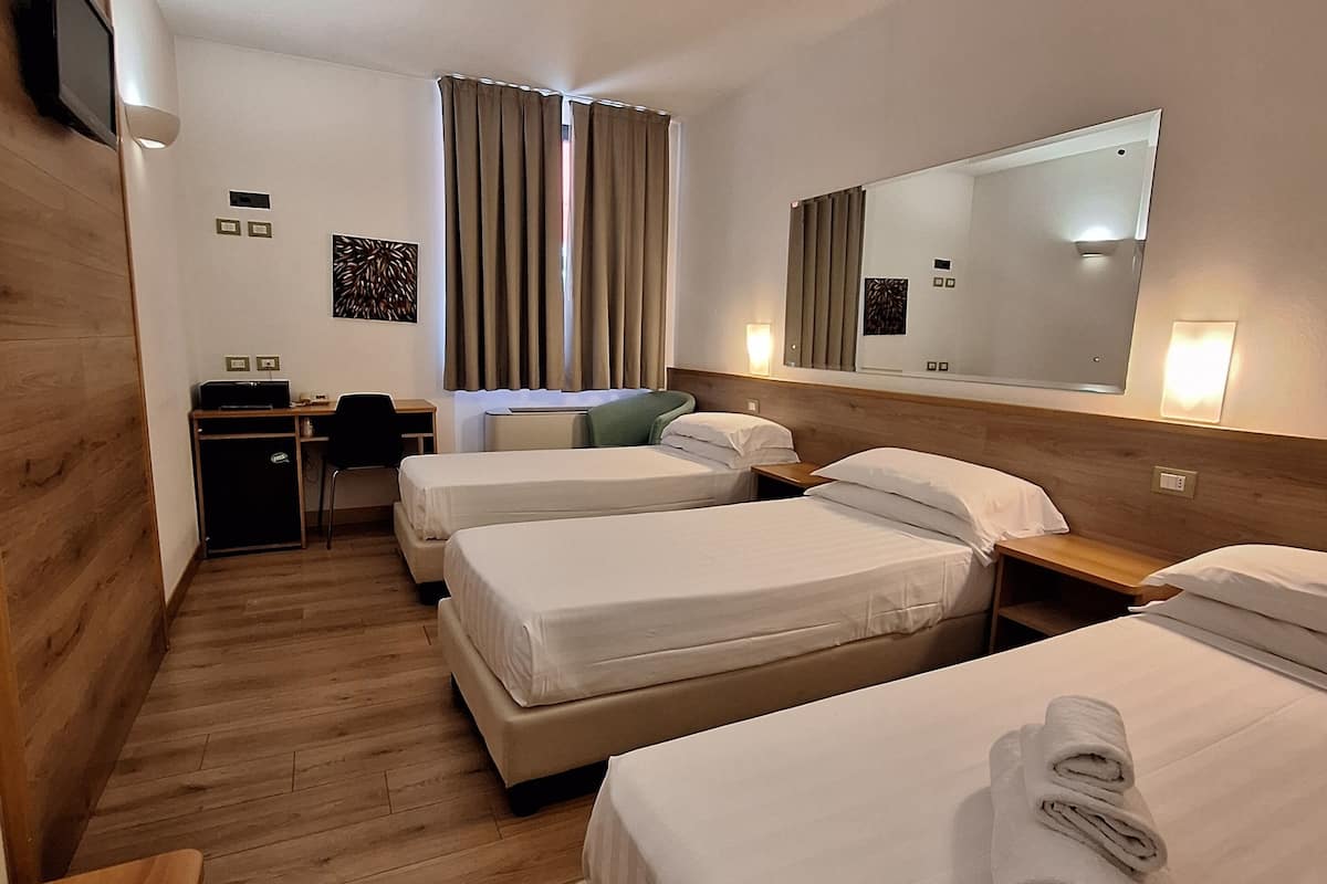 Camera tripla | Lenzuola Frette, materassi Select Comfort, minibar