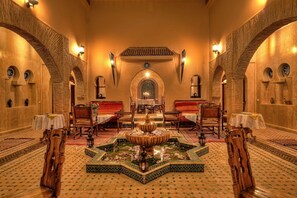 A luxurious interior with a central fountain, ornate furniture, and traditional decor. - Villa Dar Mya Palmiers (Marrakech)