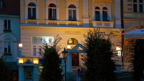 A historic building with ornate architecture, multiple balconies, and a sign indicating it is a hotel. - Hotel Heluan (Karlovy Vary)
