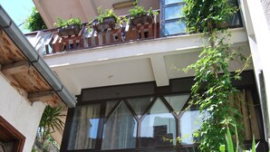 A multi-story building with balconies, a sign reading "ROOMS COBI," and a sign for "Apartments Kosta Lower Gate." - Apartments Kosta (Ohrid)