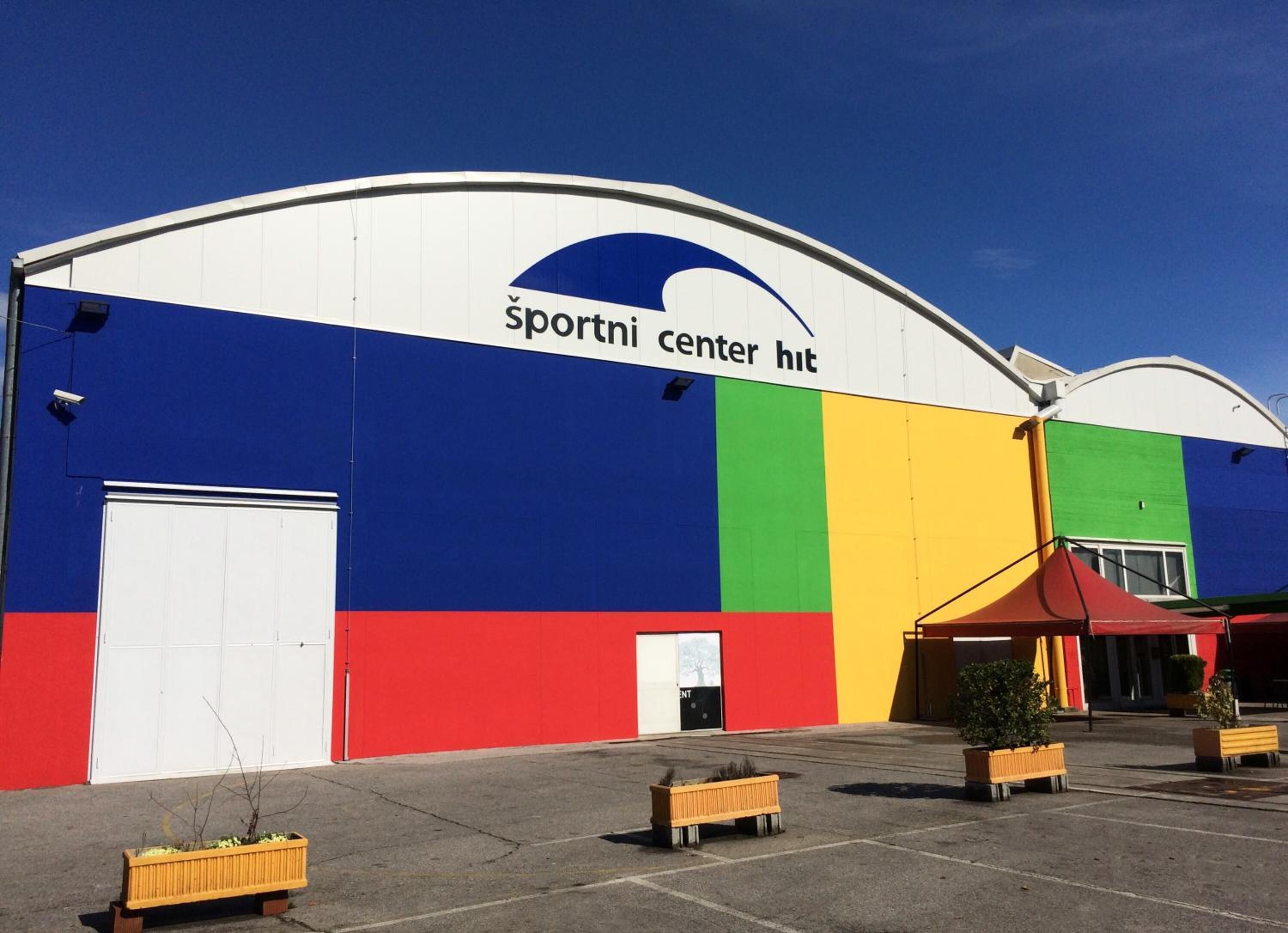 Un edificio con fachada colorida y un letrero que dice "sportni center hut".