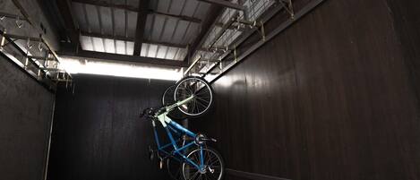 A narrow, enclosed space with a bicycle mounted on a wall.
