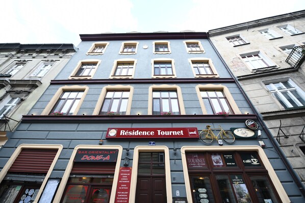 A building with a sign reading "Residence Tournet" and a bicycle parked outside. - Résidence Tournet (Kraków)