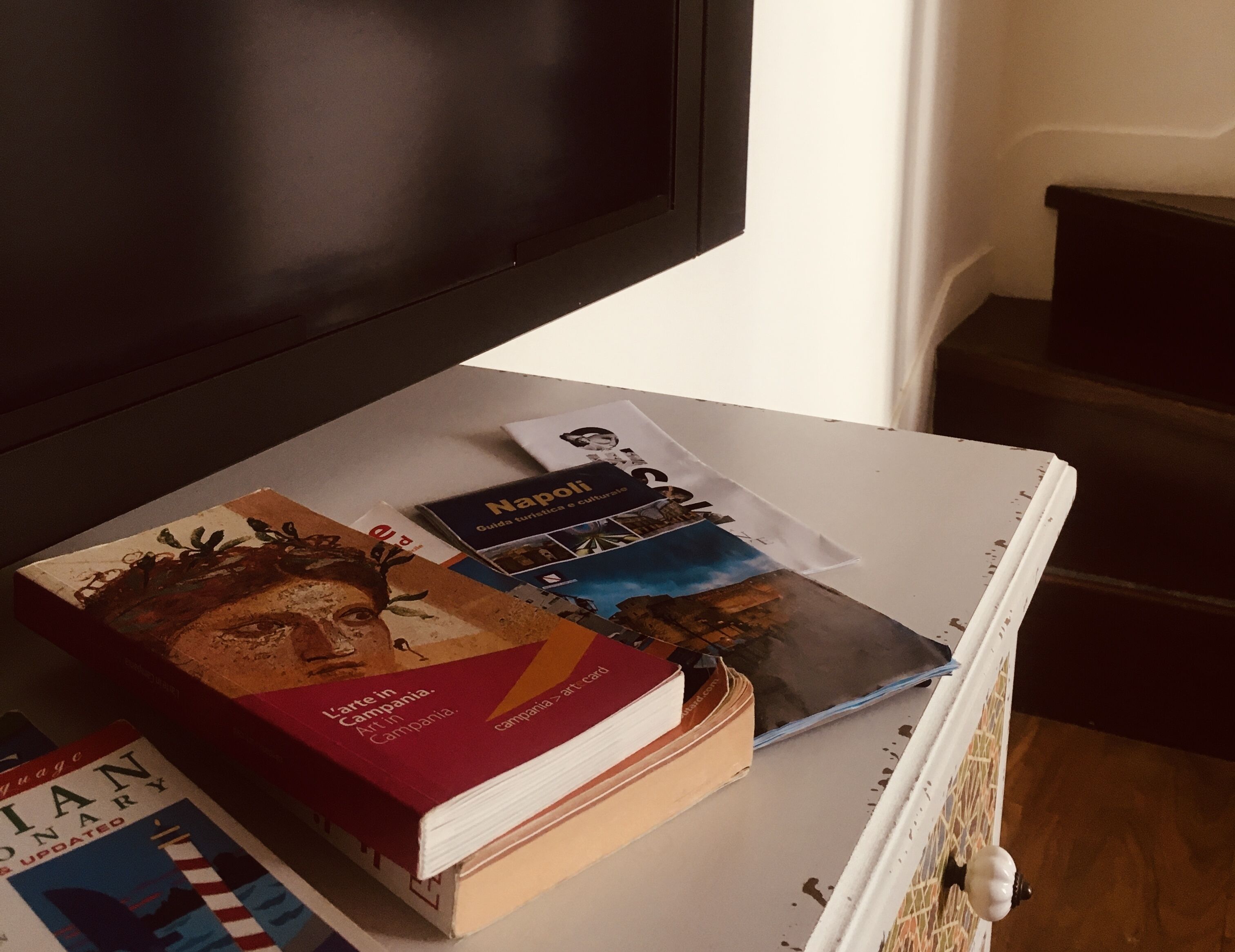 A table with books and a travel guide on it.