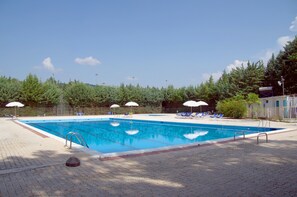 Outdoor pool, open 9:00 AM to 6:00 PM, pool umbrellas, pool loungers