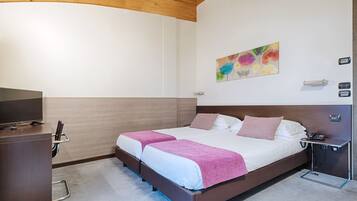 Ein Schlafzimmer mit einem Bett, Nachttischen, einem Fernseher und einem Bild an der Wand.