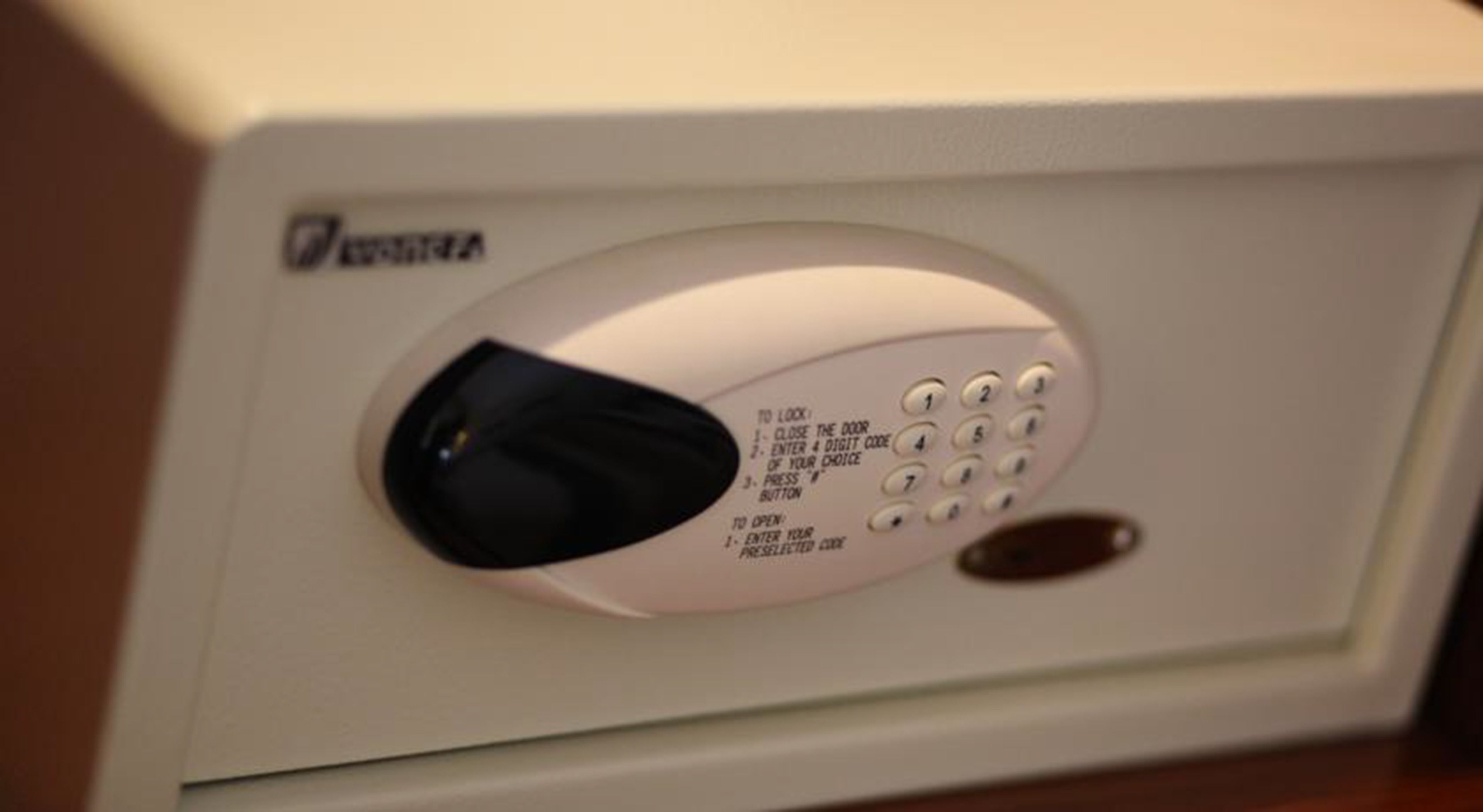 A white electronic keypad with instructions for locking and unlocking a door.