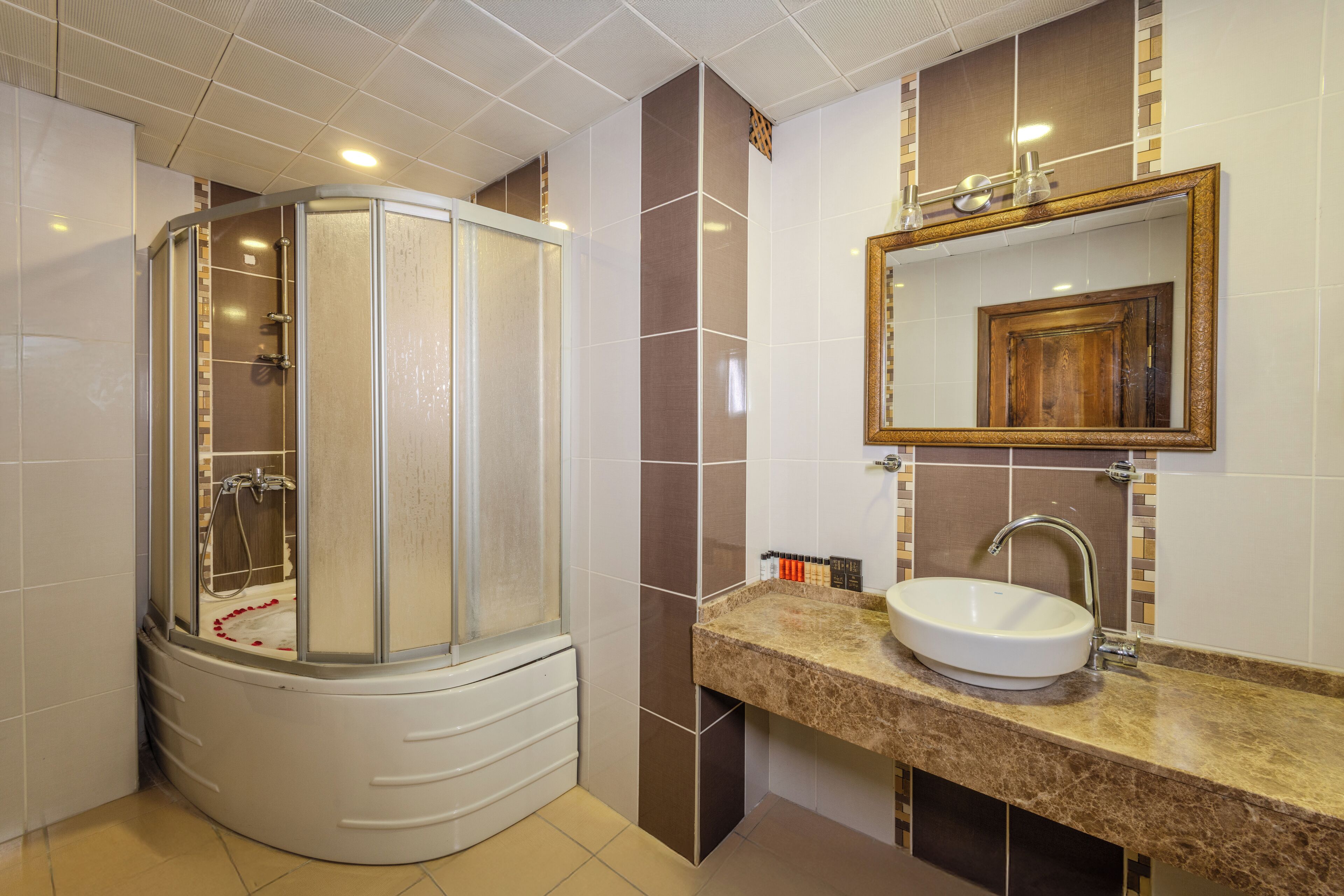 deluxe room | bathroom | shower, free toiletries, hair dryer, slippers