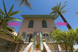 A building with a symmetrical facade, arched windows, and a central entrance with a staircase. - Hotel Villa Roseraie (Vence)