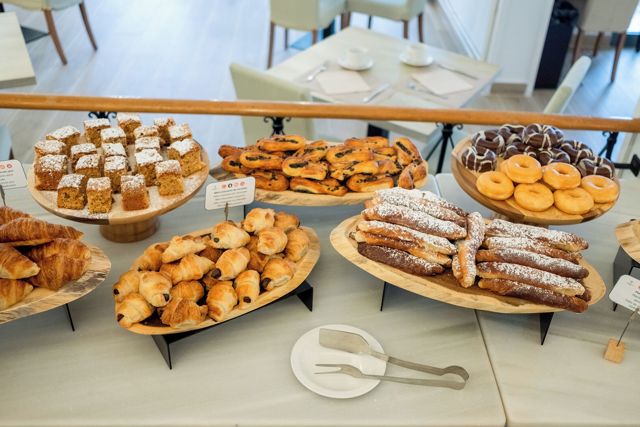 A bakery display with various pastries and desserts.