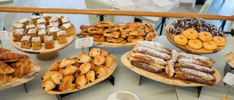 A bakery display with various pastries and desserts.