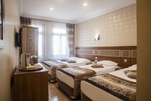 A hotel room with two beds, a wooden headboard, a bedside table with a lamp, and a window with sheer curtains. - Best Nobel Hotel (Istanbul)