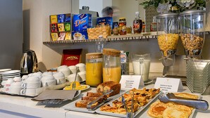 A breakfast buffet with various food items, coffee, and tea options. - Hotel La Pace (Viareggio)