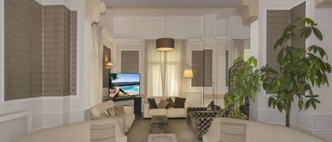 A living room with a sofa set, a coffee table, and a television.