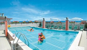 Piscina a l'aire lliure de temporada, para-sols i gandules 