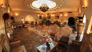 A grand lobby with ornate furniture, a central chandelier, and a large decorative vase. - Oriental Rivoli Hotel & SPA (Sharm El Sheikh)