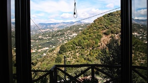 A view from a window overlooking a mountainous landscape with a clear sky. - Casarufolo Paradise (Sorrento)