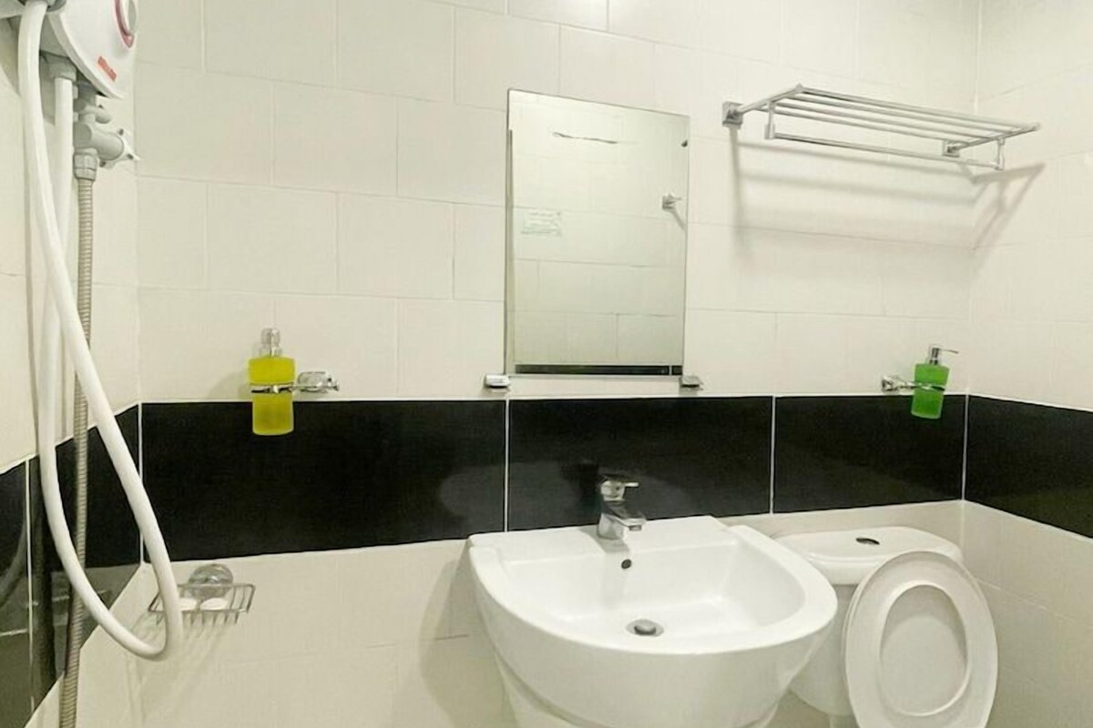 A bathroom with a sink, toilet, and shower.