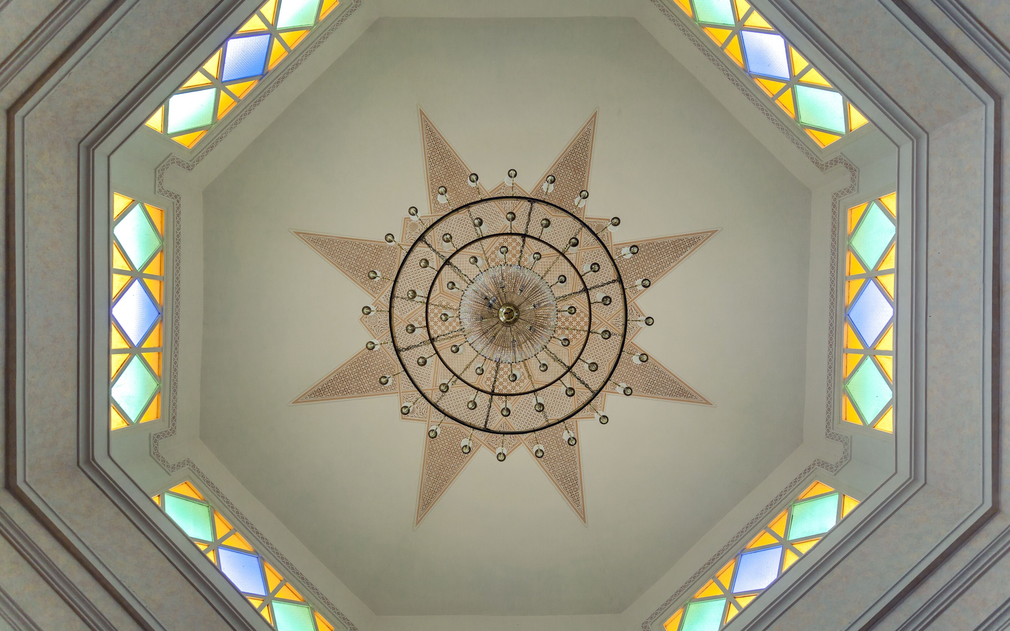 A star-shaped ceiling with a central circular design and surrounding geometric patterns.