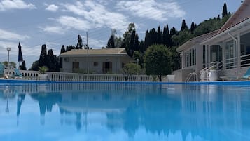 Seasonal outdoor pool, open 8 AM to 7 PM, pool umbrellas, pool loungers