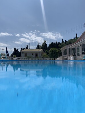 Seasonal outdoor pool, open 8 AM to 7 PM, pool umbrellas, pool loungers