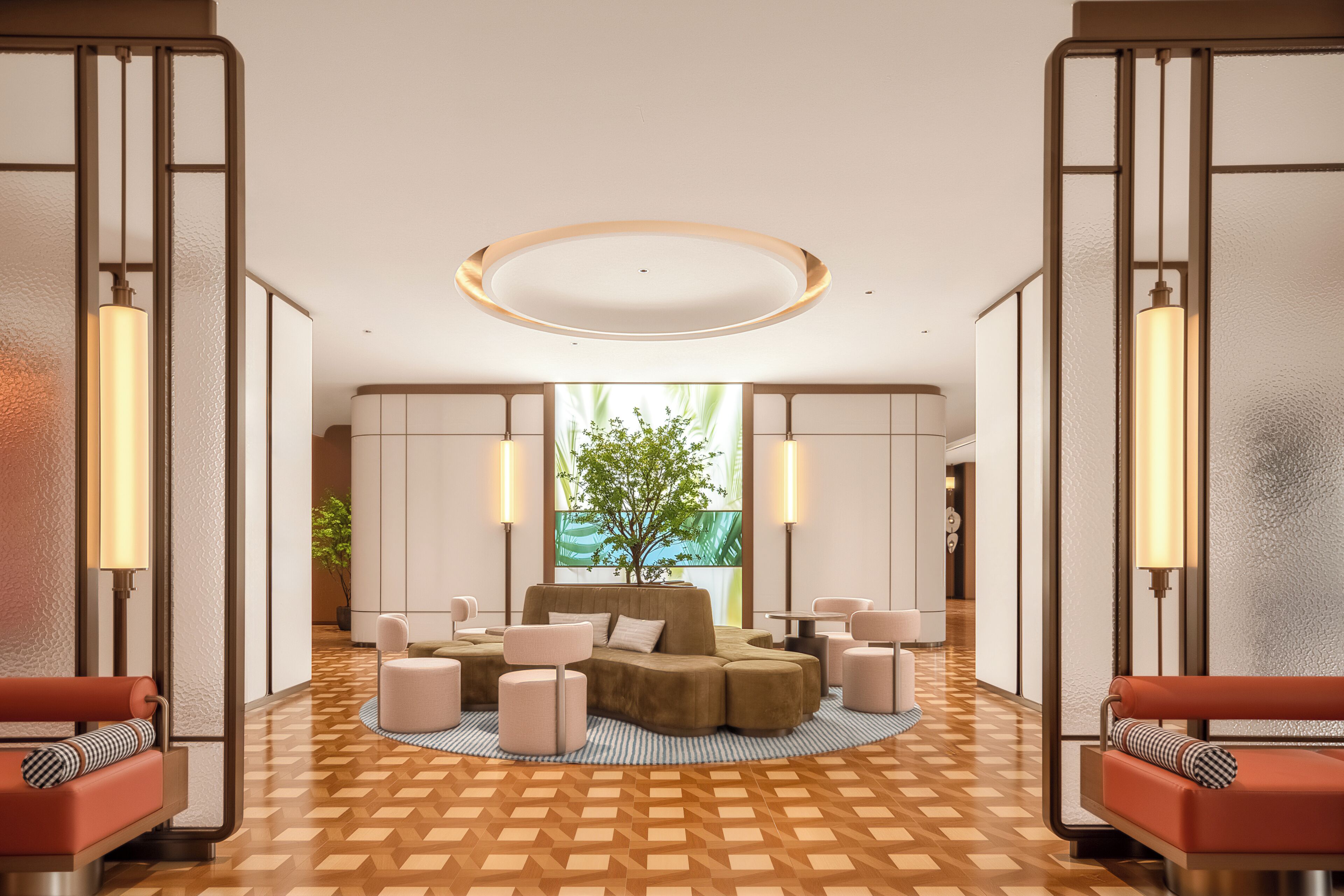 A modern lobby with a central seating area, a large window with a view of greenery, and a geometric patterned floor.