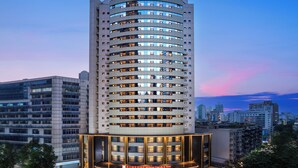 A high-rise hotel with multiple floors, a well-lit entrance, and a visible name sign. - Hilton Garden Inn Chengdu Tianfu Square Center (Chengdu)