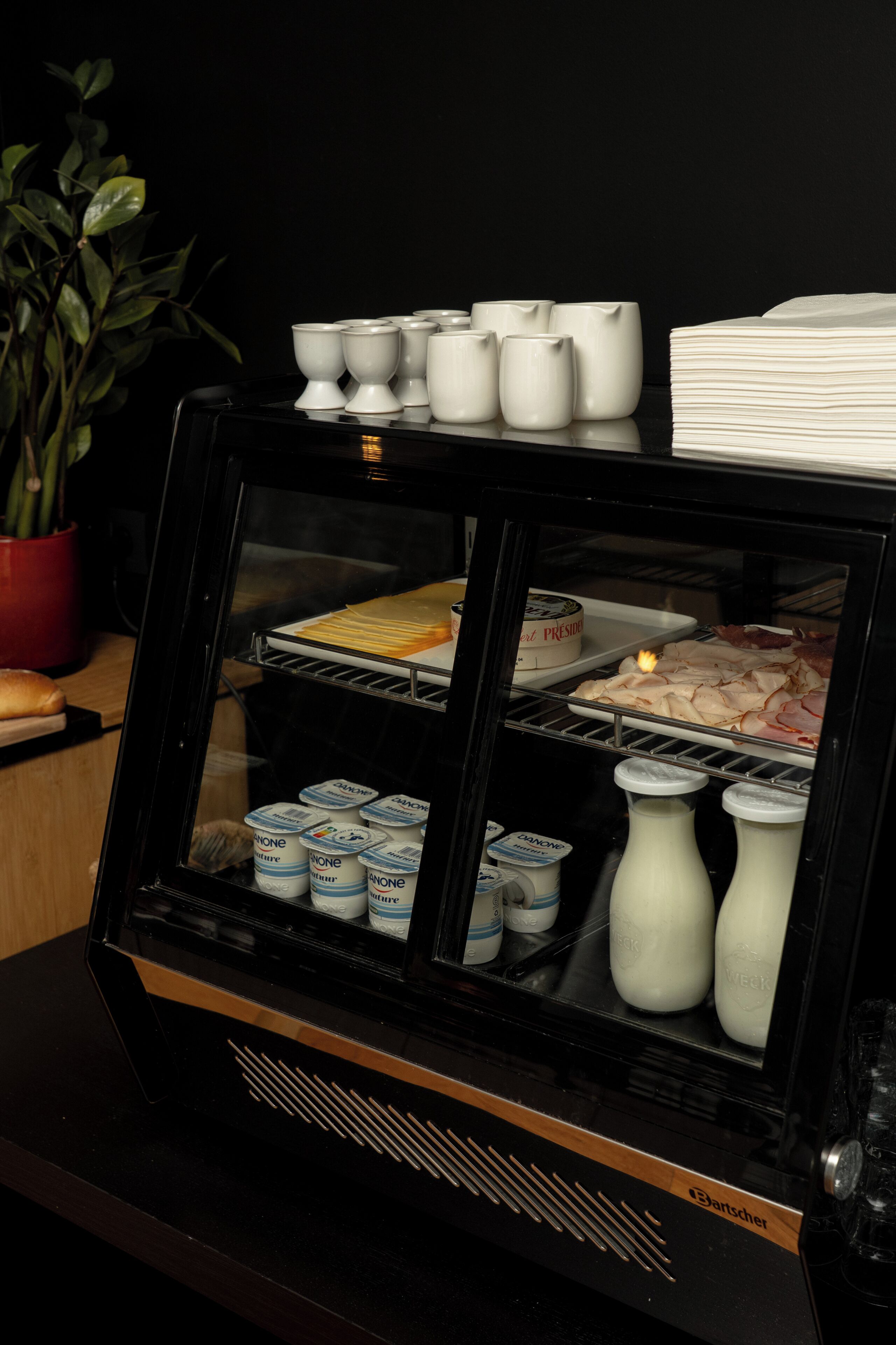 A food display case with various food items and condiments.