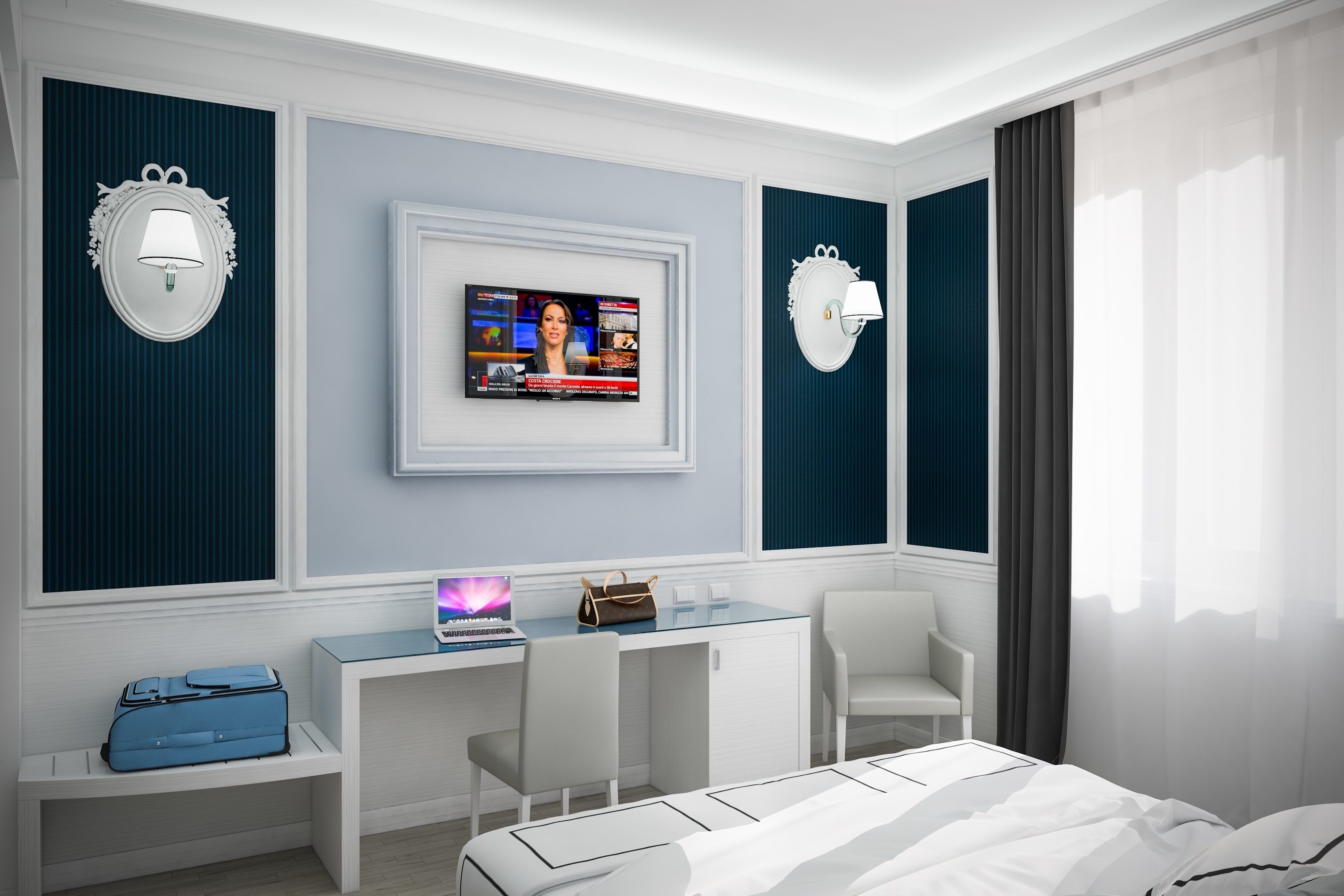 Una moderna camera d'albergo con un letto, una scrivania con un portatile, una televisione e un'area salotto.