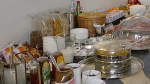 A buffet table with various food items, including fruits, condiments, and beverages. - Brandenburger Hof (Cologne)