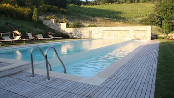 Ulkouima-allas, uima-allas vesiputouksella, aurinkotuoleja