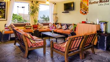 Relax in the lounge area with a variety of seating options and a large window offering a view of the outdoors.