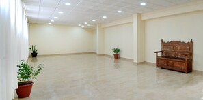 Relax in a serene space with a polished tile floor, wooden bench, and lush greenery.