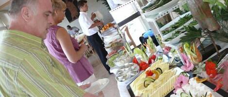 A buffet with various food items and decorations.