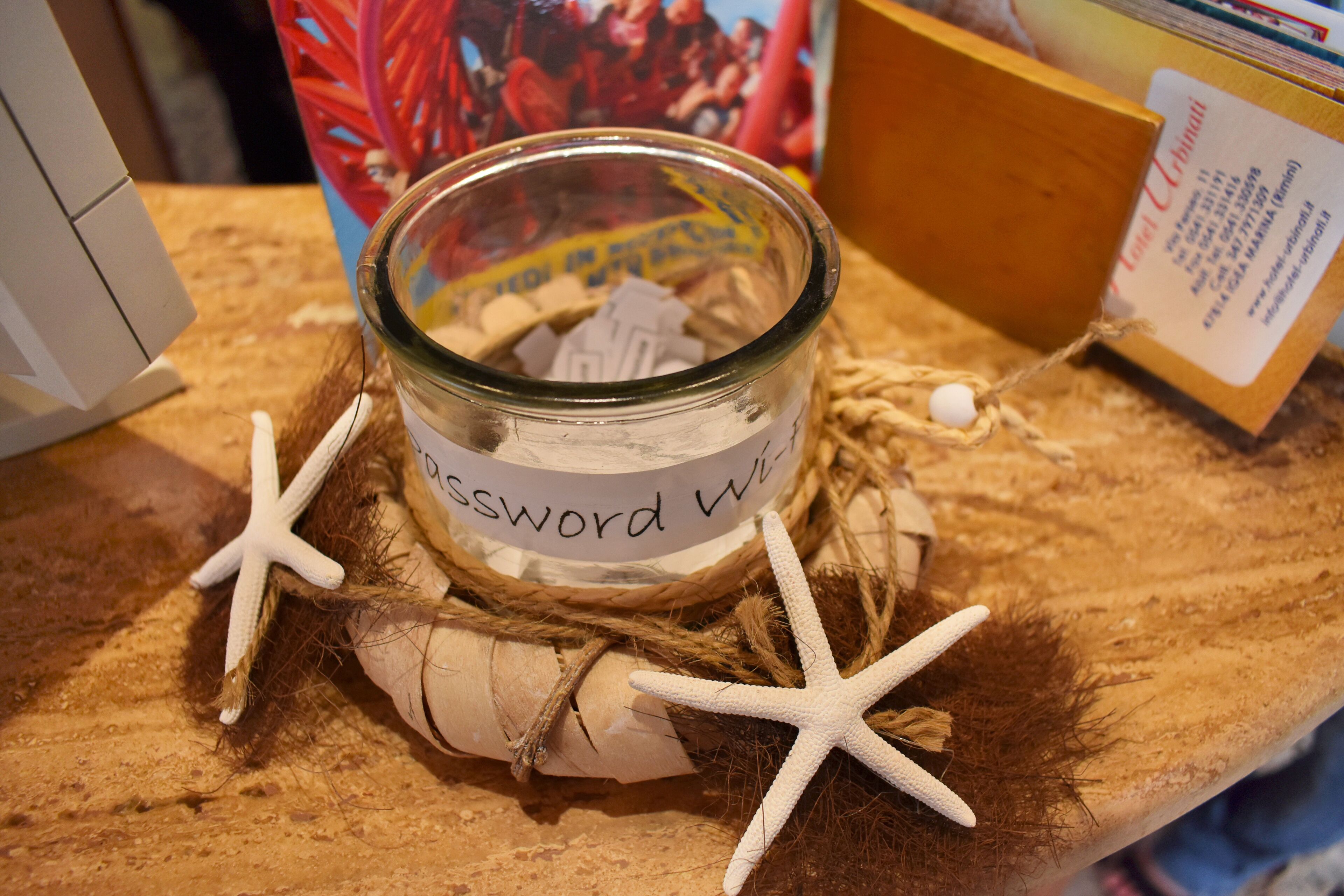 A glass jar with a label reading "Password WiFi" surrounded by starfish and a rope.