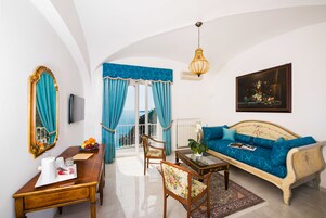 Una habitación con sofá, mesa de comedor, silla, espejo y televisor.