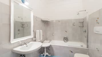 A bathroom with a sink, toilet, and bathtub.