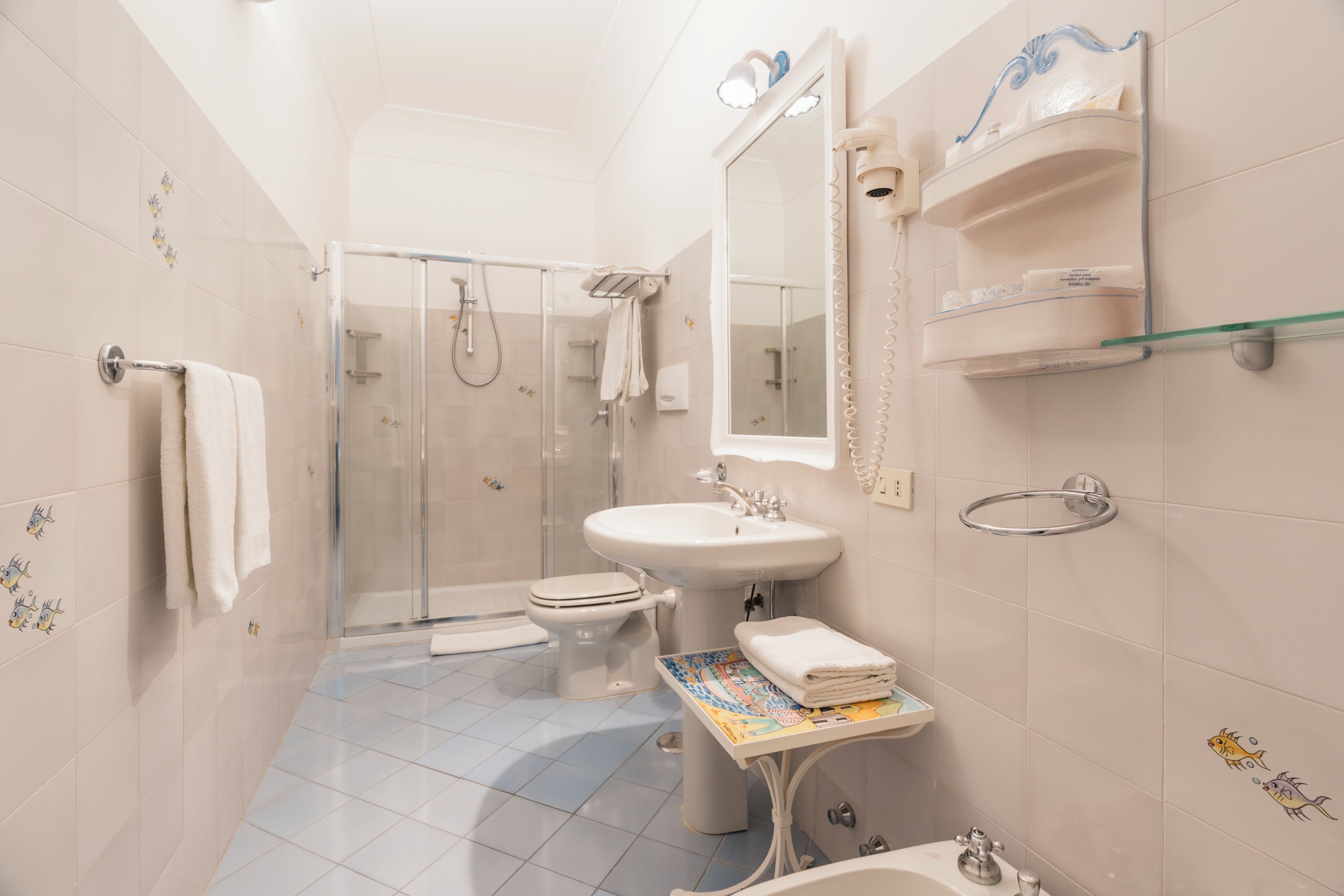 A bathroom with a shower, toilet, sink, and bathtub.
