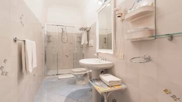 A bathroom with a shower, toilet, sink, and bathtub.