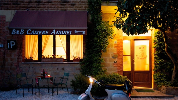 A restaurant with outdoor seating and a scooter parked in front. - B&B Camere Andrei (Pienza)